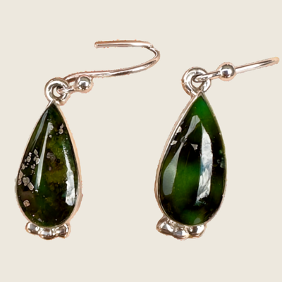 Sonoran Mountain turquoise teardrop earrings in sterling silver, shown on a bone linen background