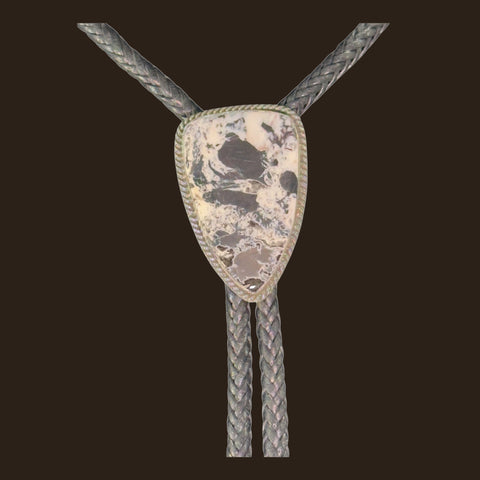 White Buffalo Bolo Tie in Navajo Sterling Silver, by P. Yazzie, shown on an espresso background