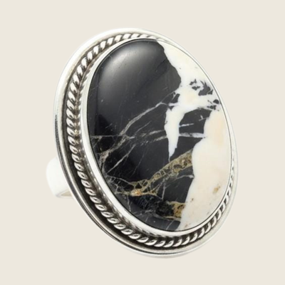 White buffalo statement ring in Navajo sterling silver by P. Yazzie, shown on a bone linen background