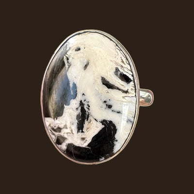White Buffalo Stone Ring in Sterling Silver, Size 7.5, shown on an espresso background