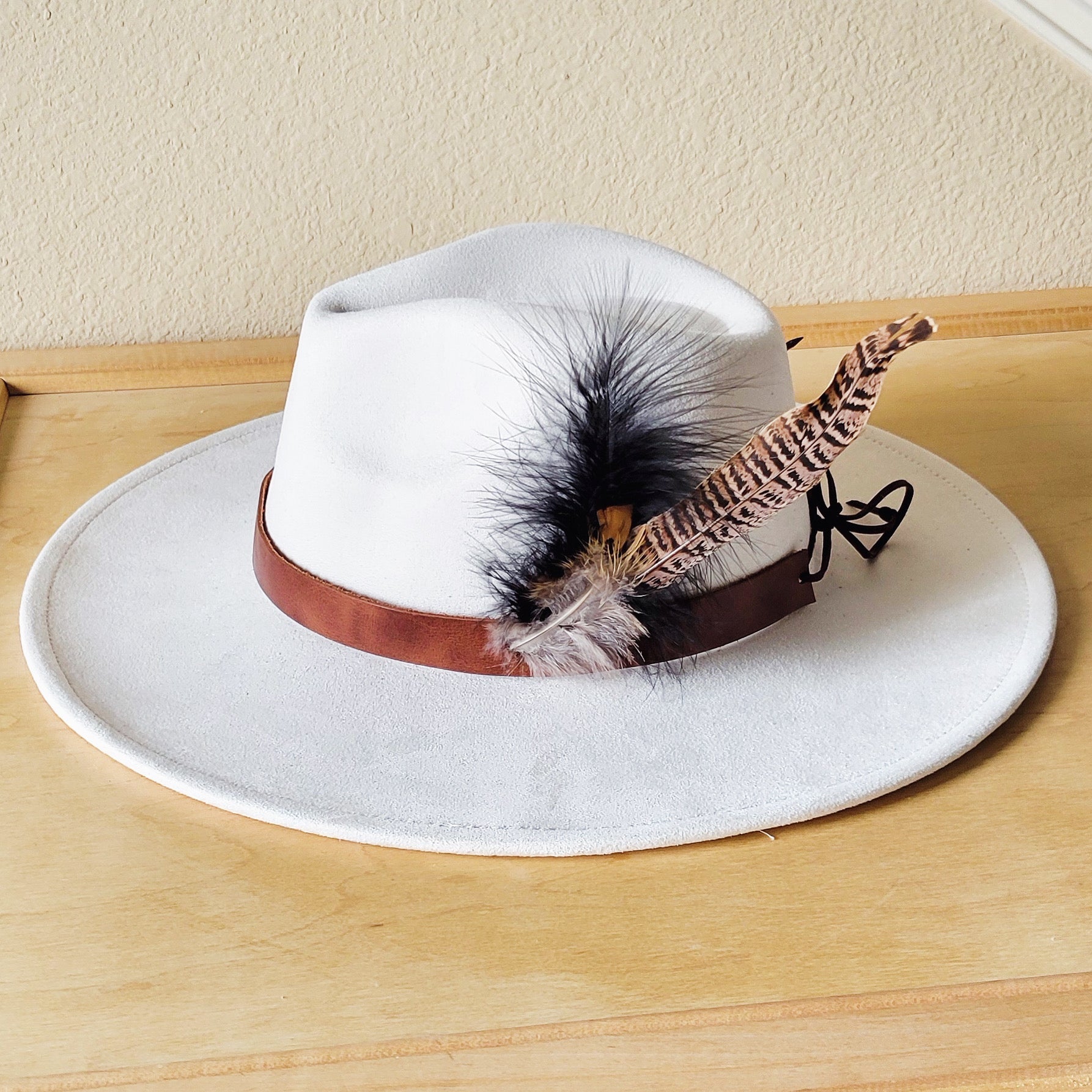 Brown leather hat band with feather accents