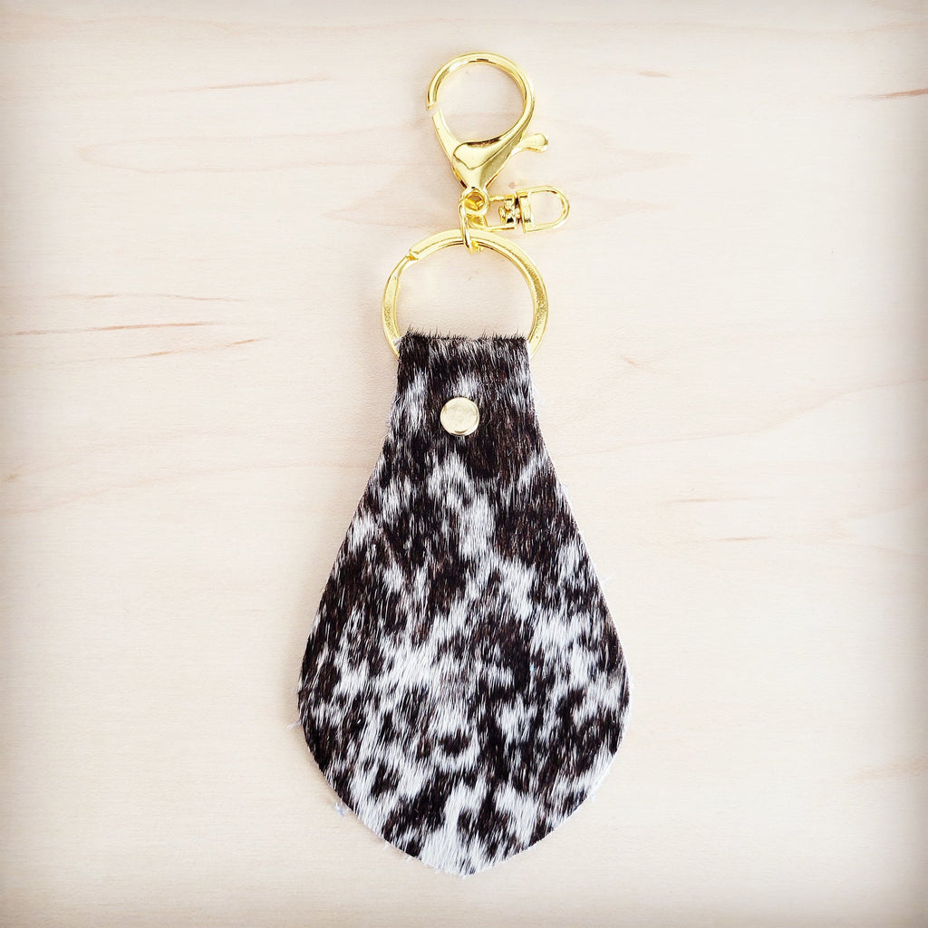 Brindle cowhide key chain shown with the full hide it is cut from