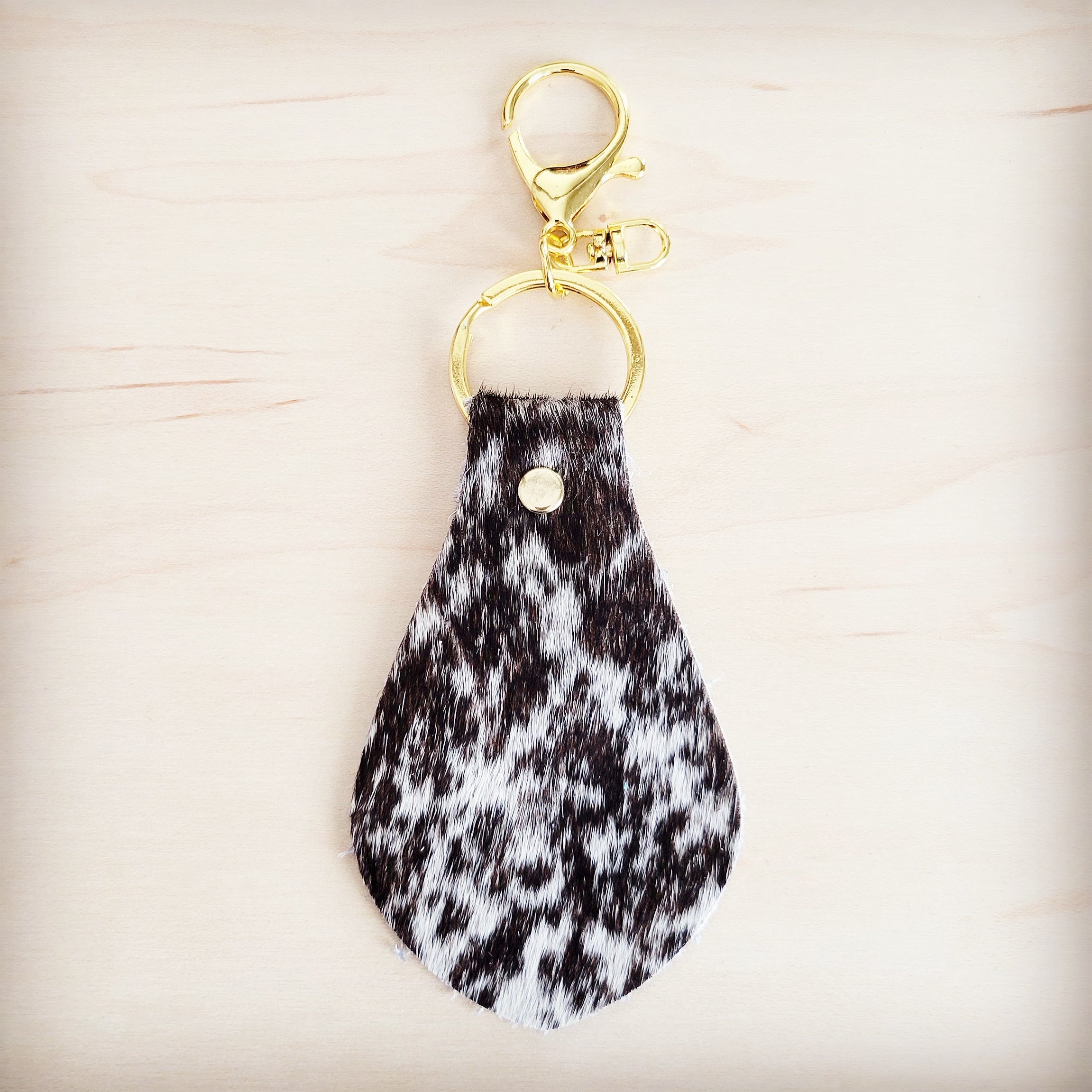 Brindle cowhide key chain shown with the full hide it is cut from
