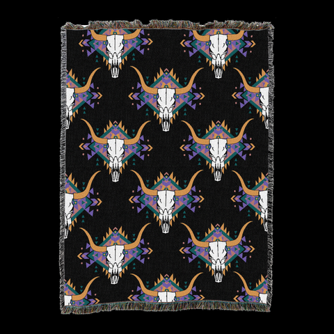 Steer skull cotton throw in the Black colorway, repeating longhorn skulls in white and tan with purple and orange feather accents on a black ground