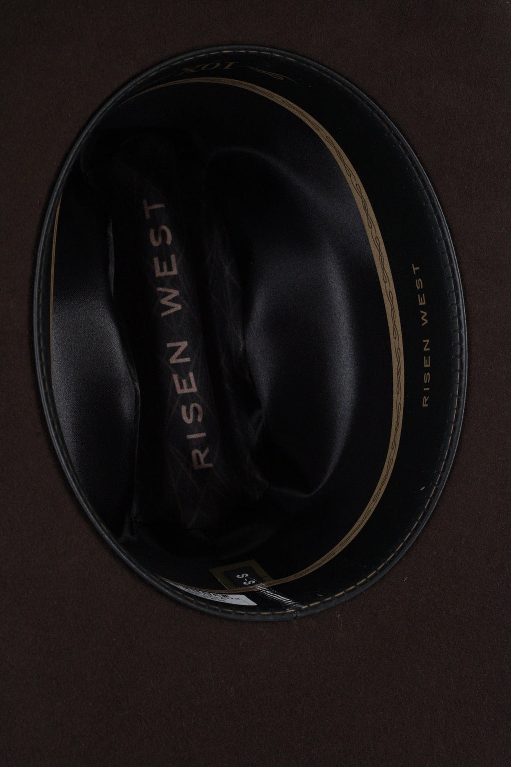 Close view inside the chocolate brown Wren cowboy hat showing the black satin lining and sweatband