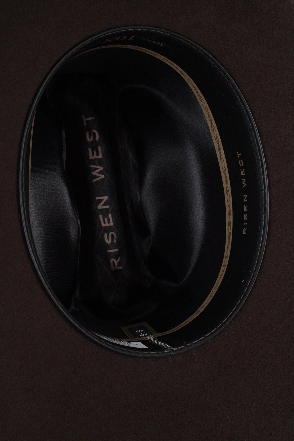 Close view inside the chocolate brown Wren cowboy hat showing the black satin lining and sweatband
