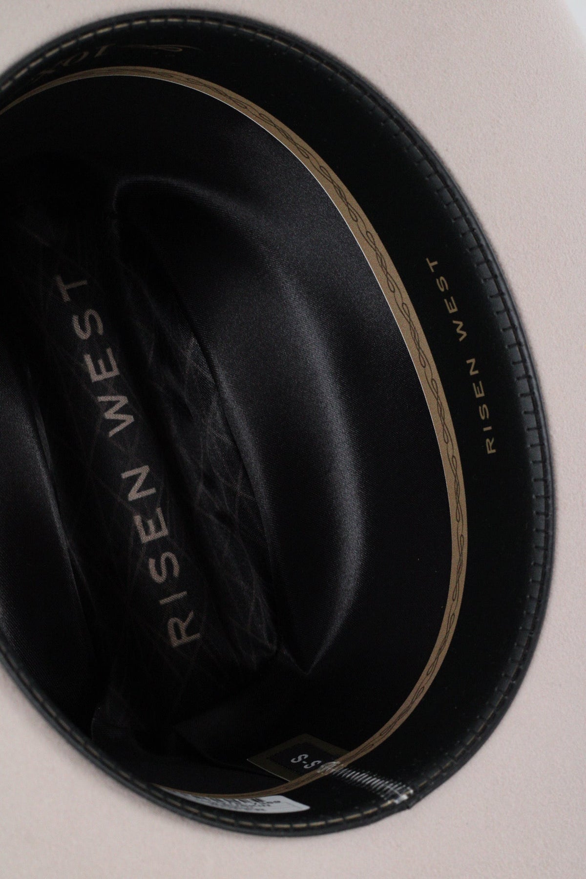 Close view inside the black Wren cowboy hat showing the black satin lining and sweatband