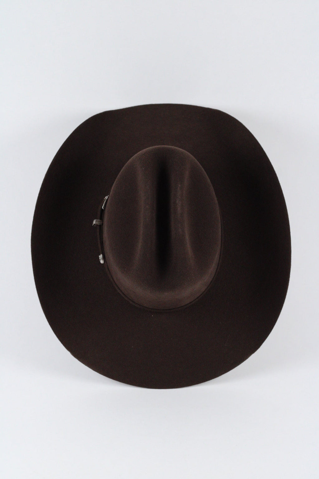 Top view of the chocolate brown Wren cowboy hat showing the creased cattleman crown and silver-tone buckle