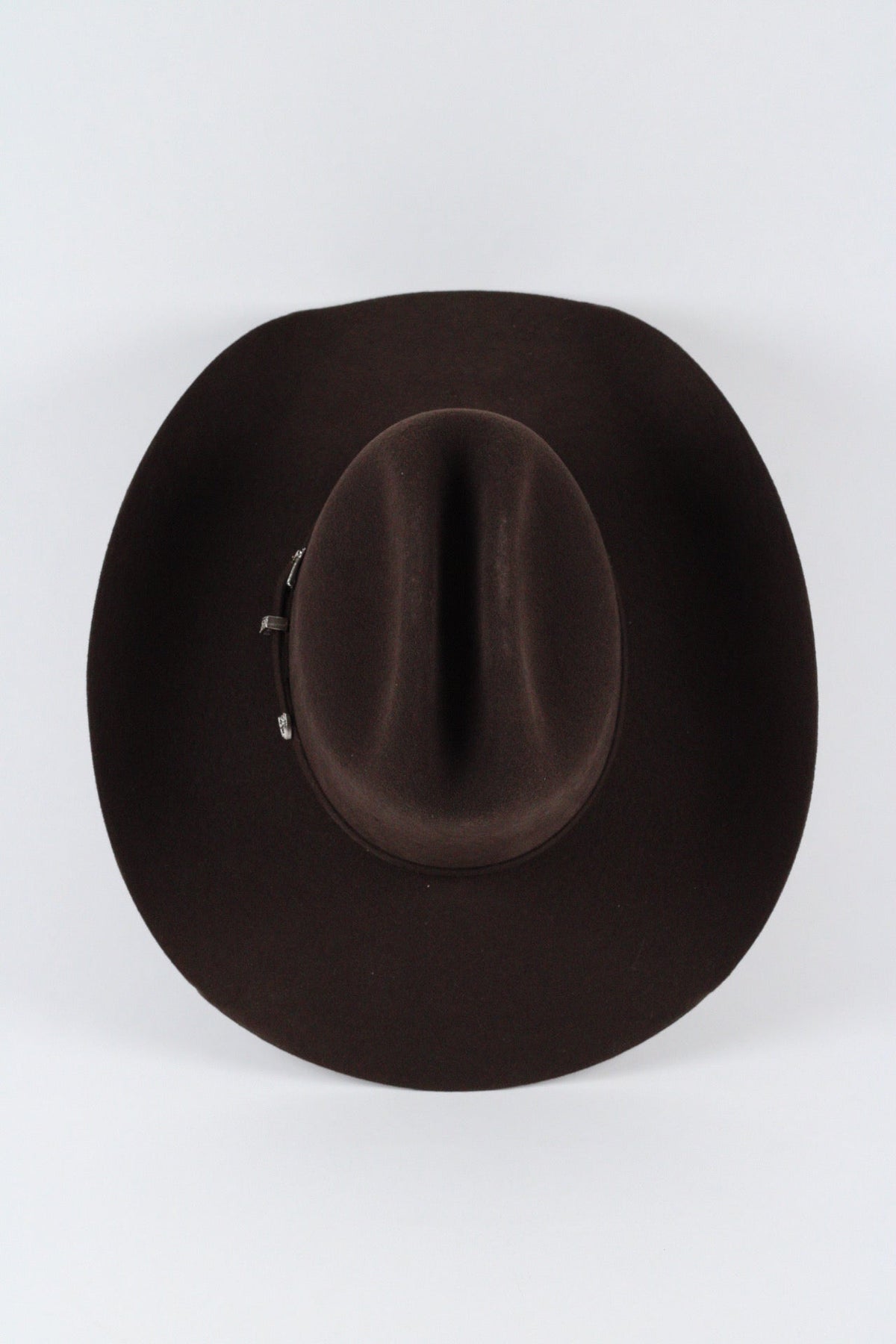 Top view of the chocolate brown Wren cowboy hat showing the creased cattleman crown and silver-tone buckle