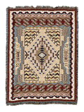 Southwest Butte cotton throw in the Clay colorway, a stepped diamond medallion on a cream field framed by layered zigzag borders in rust, navy and blue grey