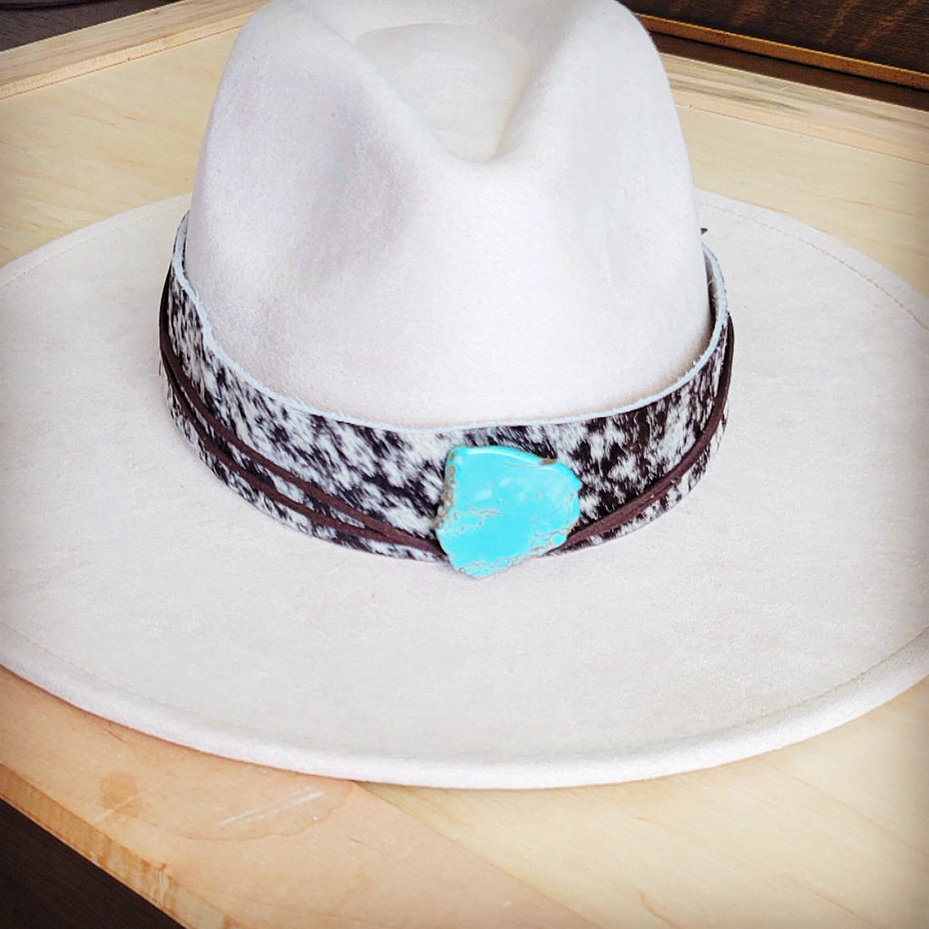 Black and white speckled hair-on-hide hat band with a turquoise-look slab