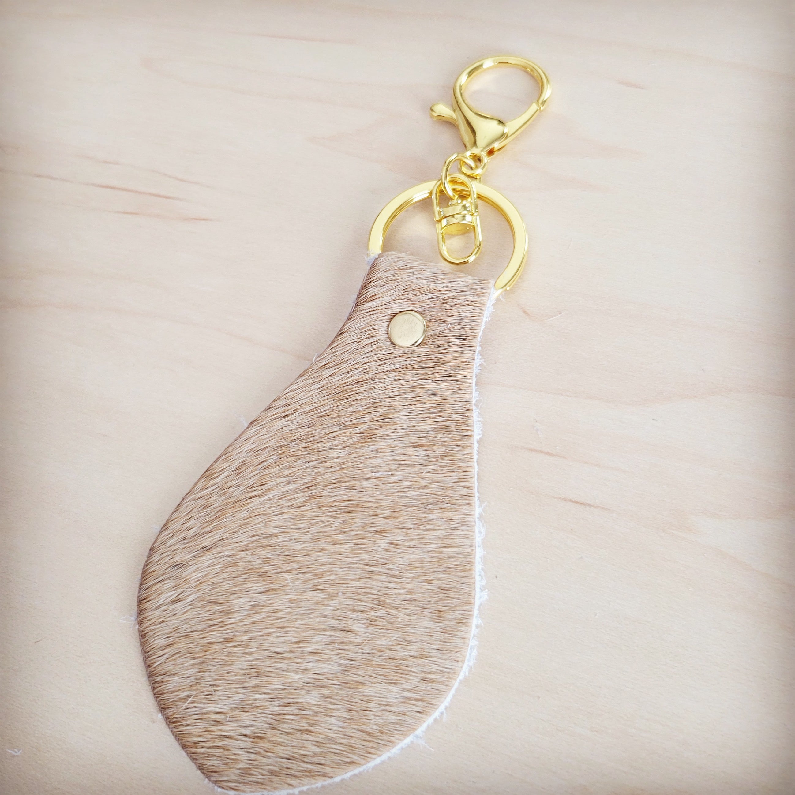 Back of the light tan hair-on-hide key chain showing the leather backing