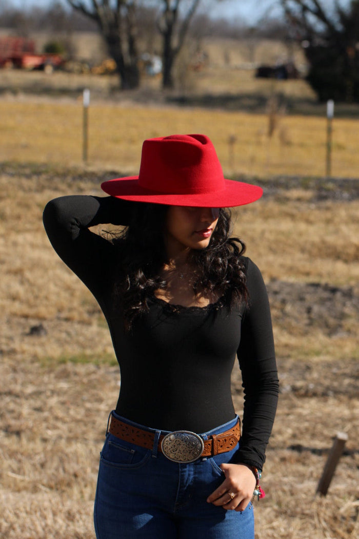 Woman wearing a red Rowan merino wool rancher hat with a wide flat brim