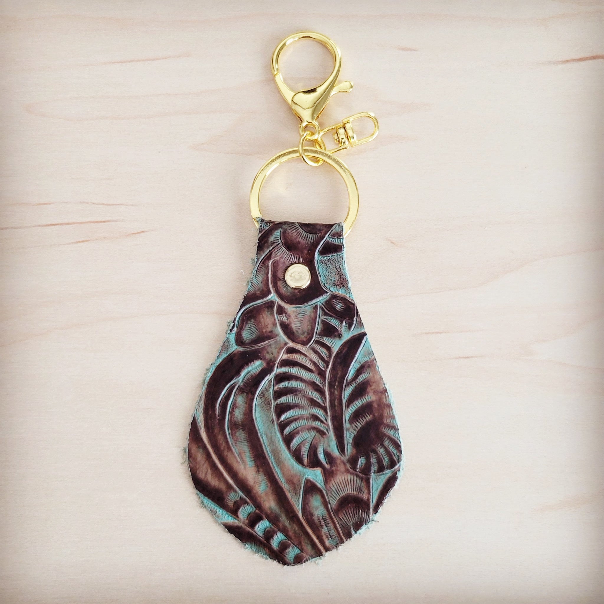 Turquoise and brown floral tooled leather key chain with gold hardware