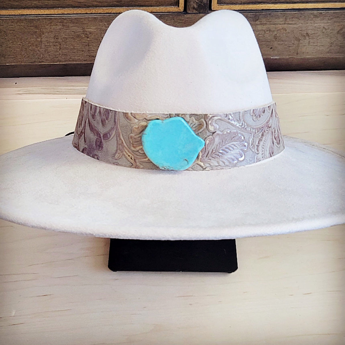 Pearl floral tooled leather hat band with a turquoise-look slab