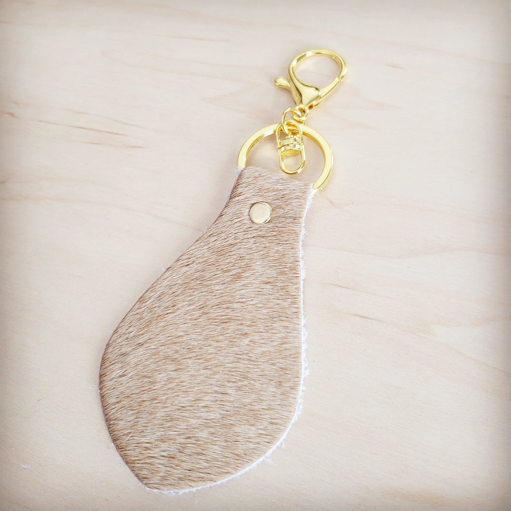 Light tan leather key chain shown clipped to a set of keys