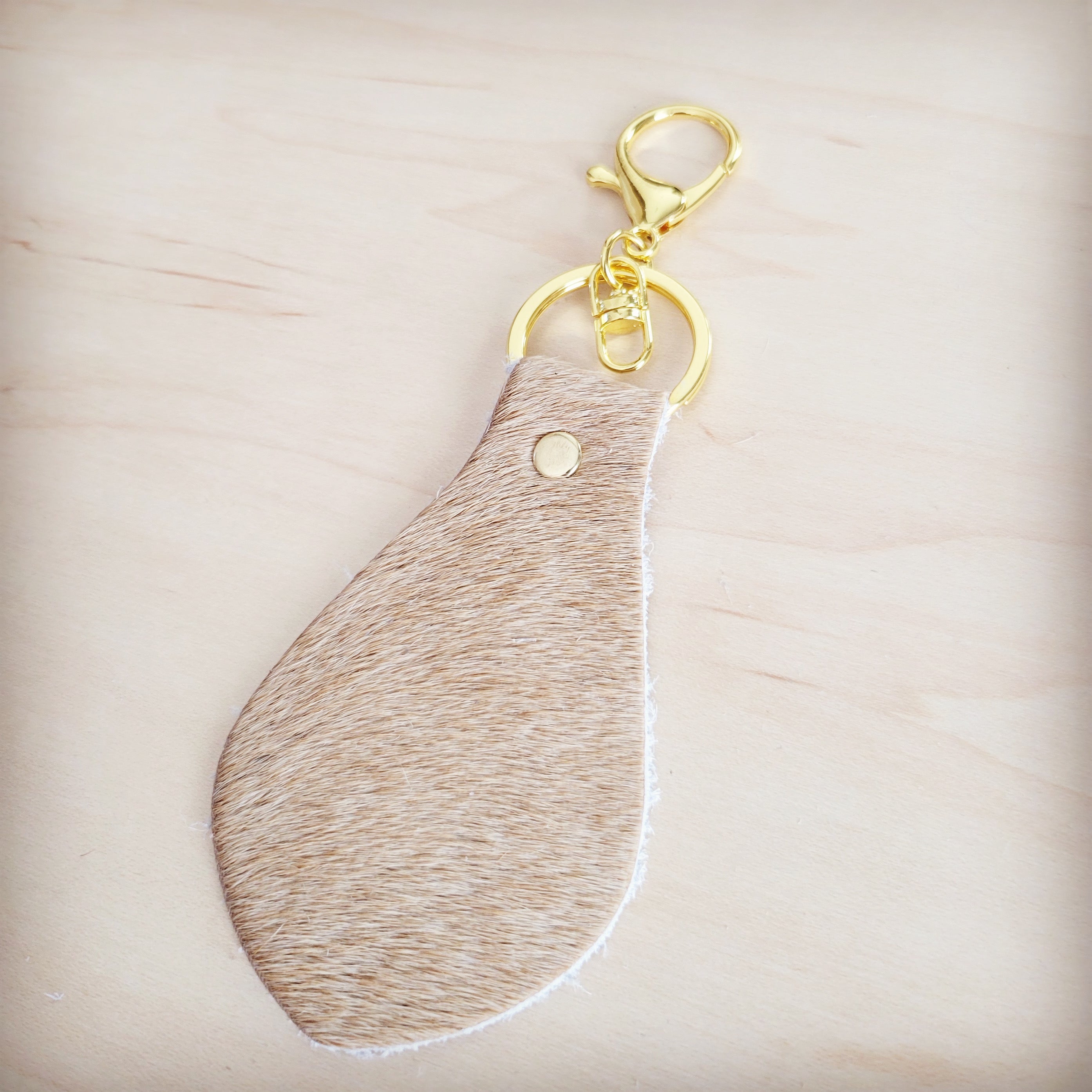 Light tan leather key chain shown clipped to a set of keys