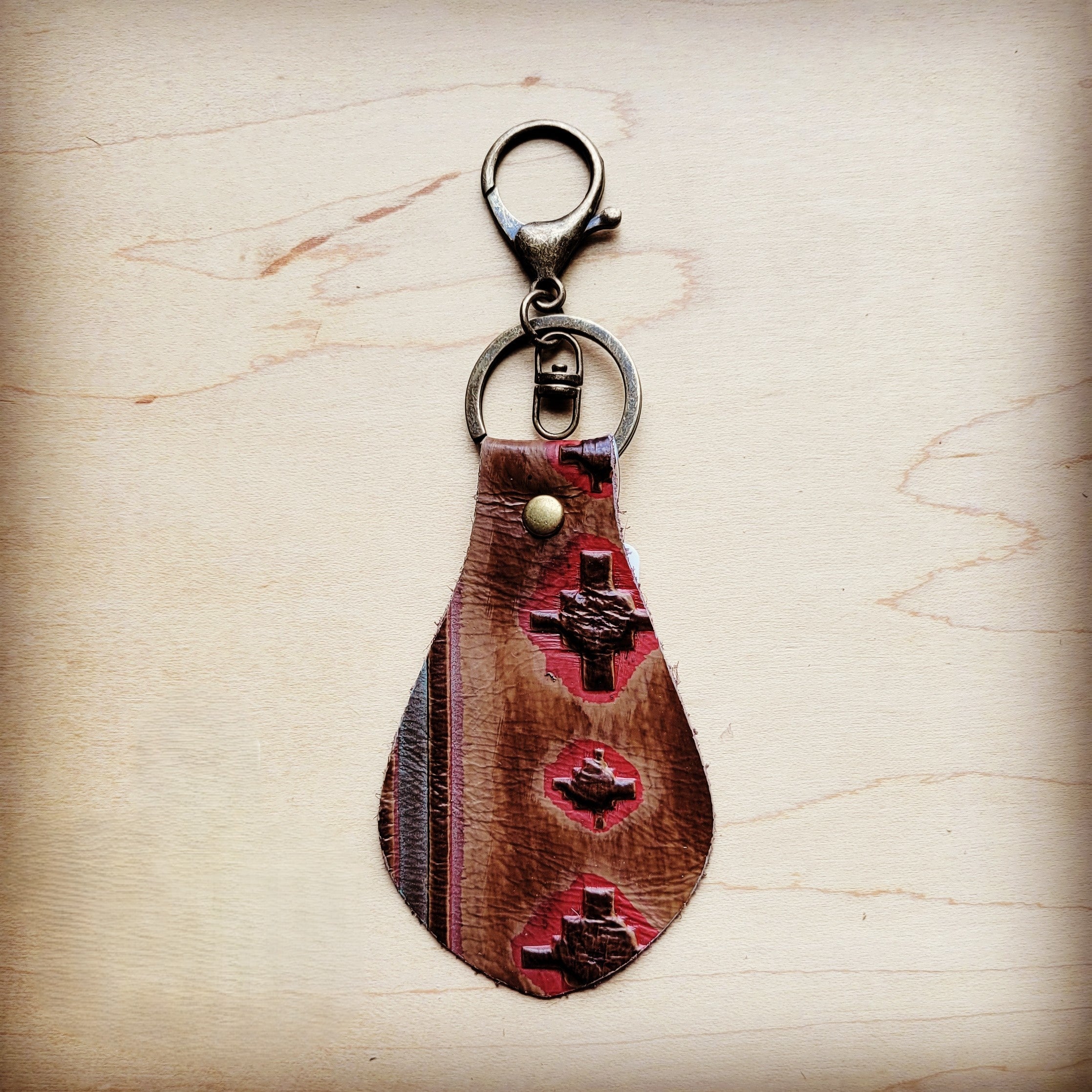 Southwest print leather key chain shown with the full hide it is cut from
