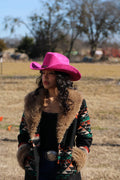 Woman wearing a magenta Durango vegan suede cowboy hat with a lifted brim