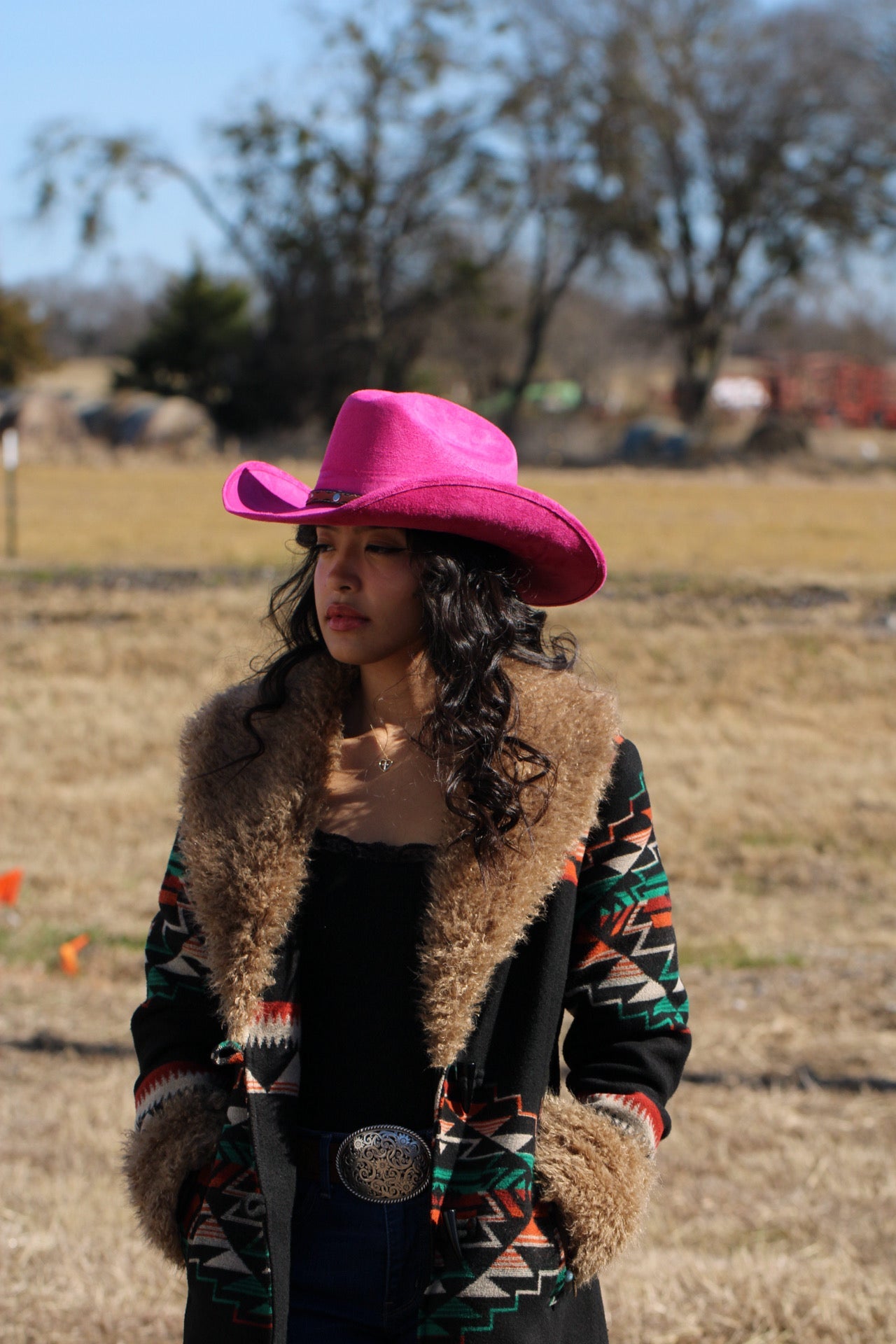 Woman wearing a magenta Durango vegan suede cowboy hat with a lifted brim