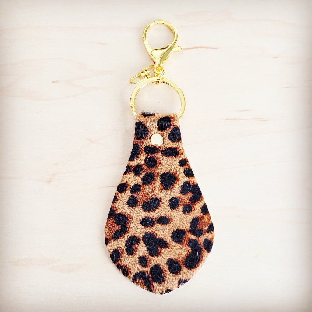Leopard print leather key chain shown alongside other hair-on-hide key fobs