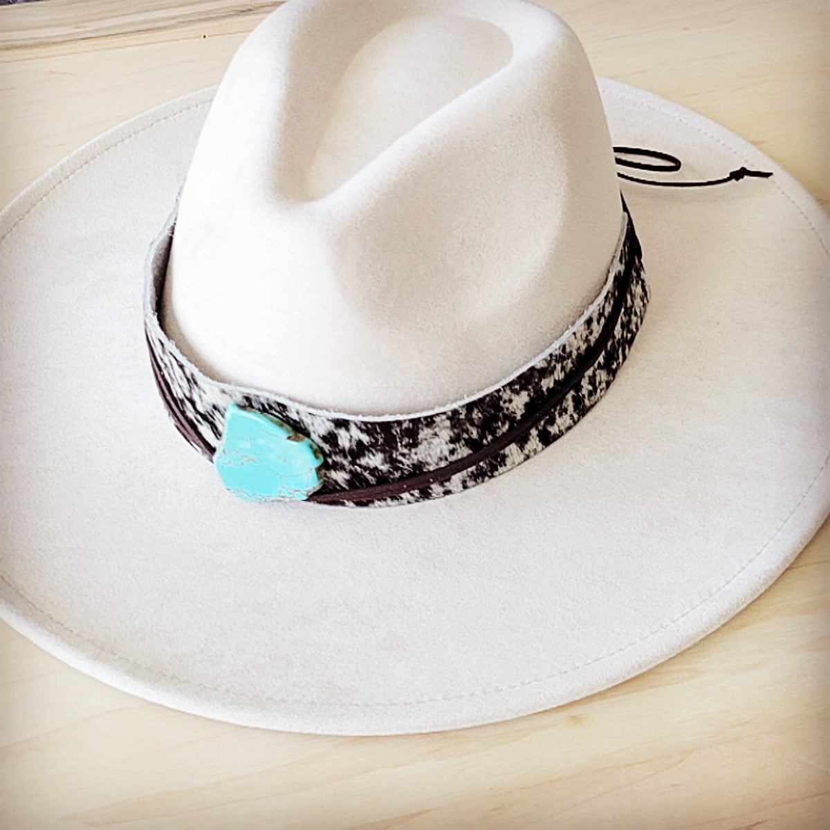 Black and white speckled hair-on-hide hat band with a turquoise-look slab, additional view