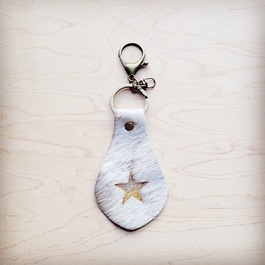 White hair-on-hide leather key chain with a branded star and swivel clip