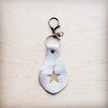 White hair-on-hide leather key chain with a branded star and swivel clip
