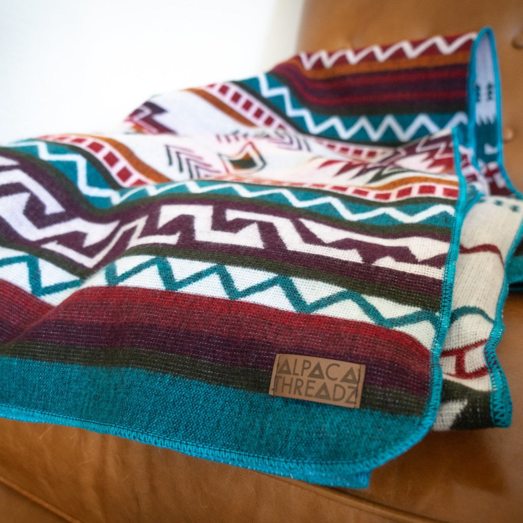 Turquoise, red and cream geometric alpaca blanket, view 7