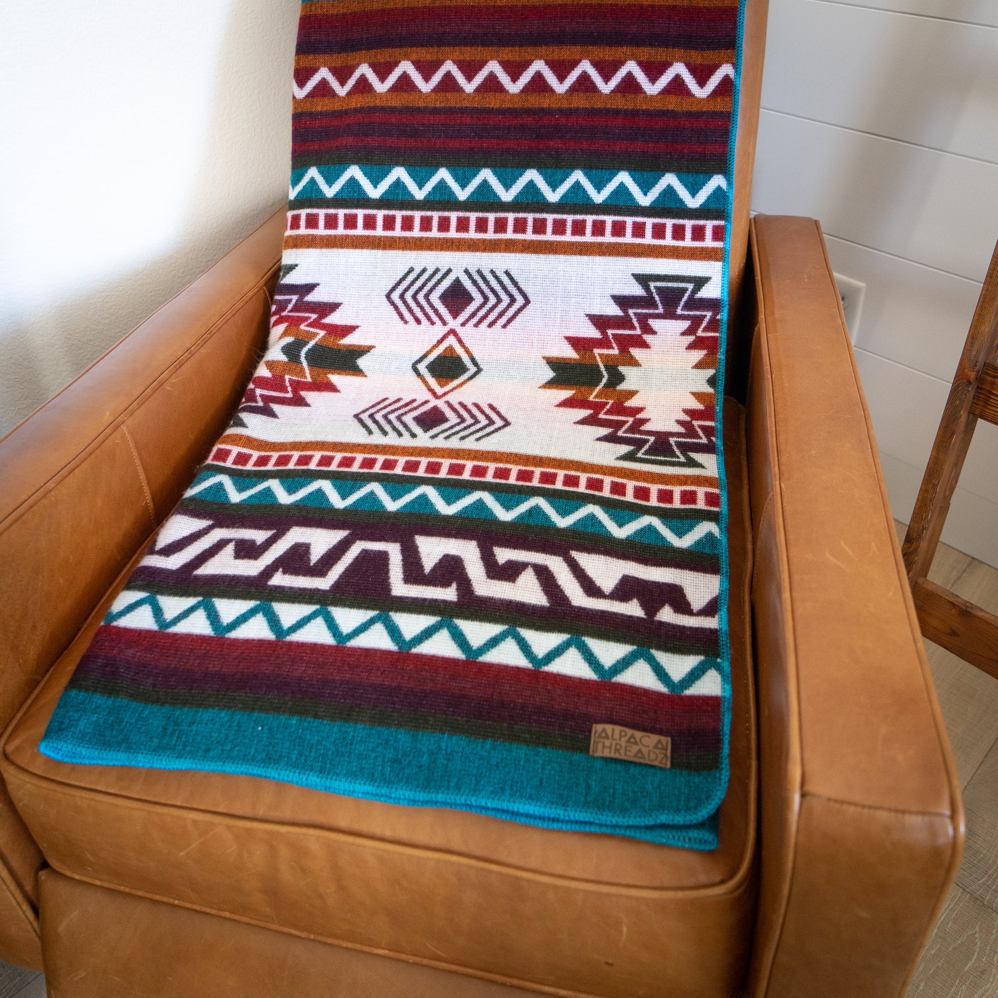 Turquoise, red and cream geometric alpaca blanket, view 4