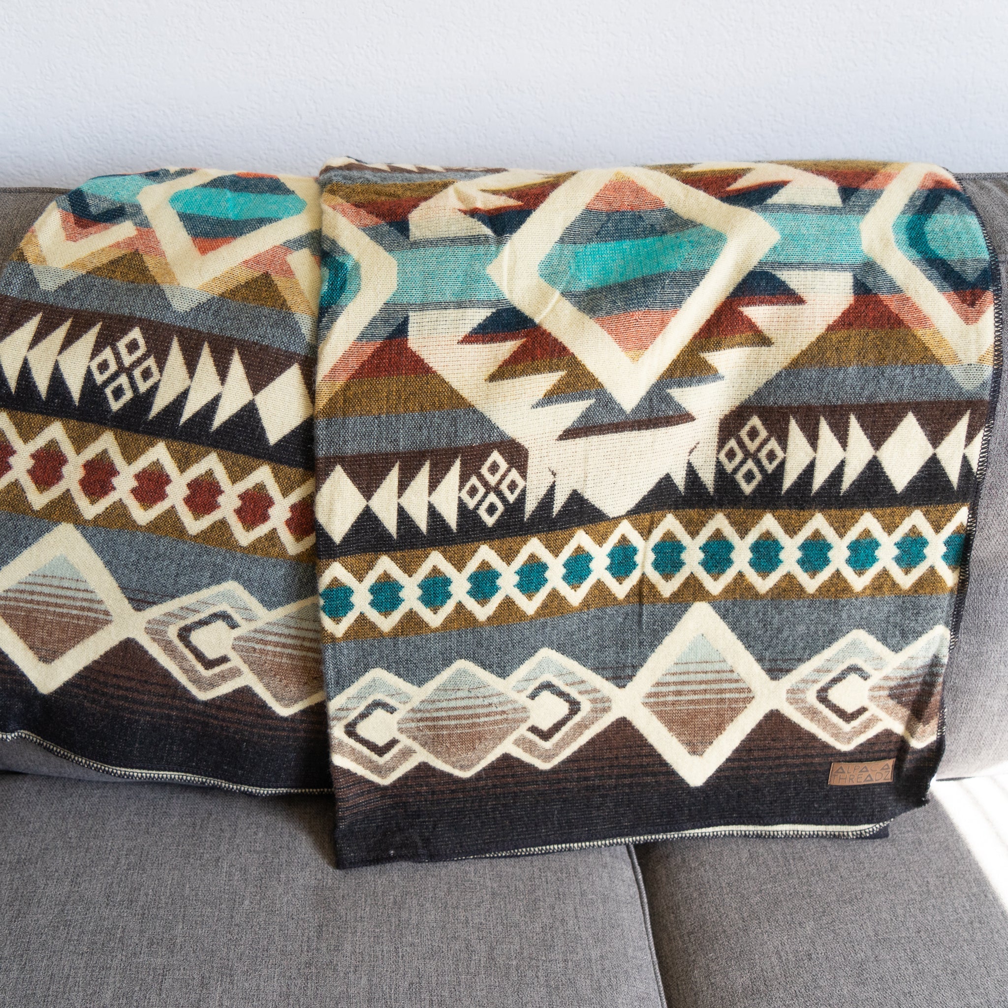 Camel, cream and turquoise geometric alpaca blanket, view 3
