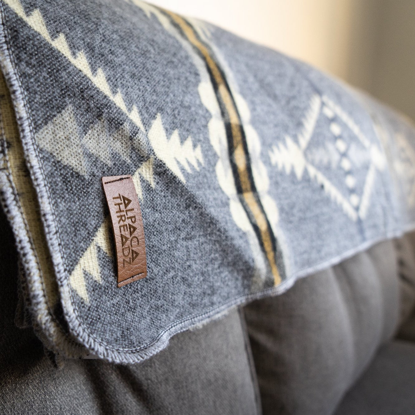 Soft grey and cream arrow and diamond alpaca blanket, view 2