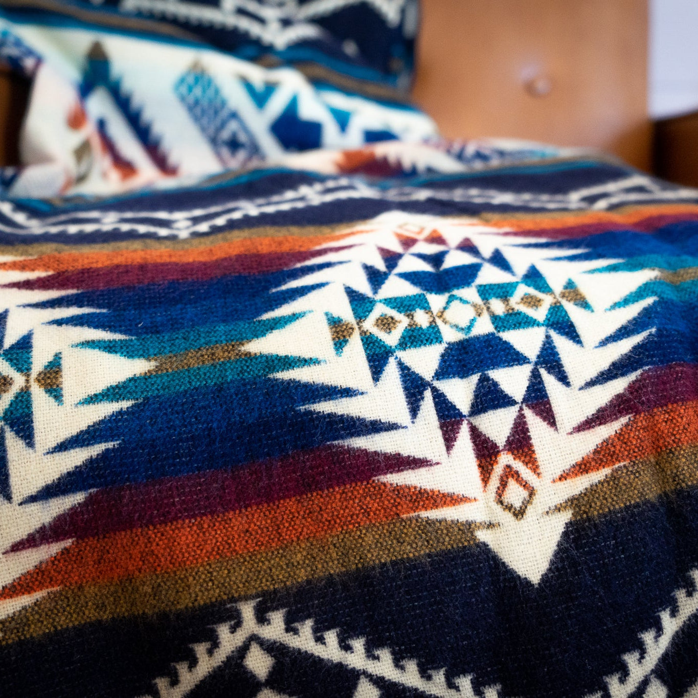 Navy, teal, rust and gold layered geometric alpaca blanket, view 8