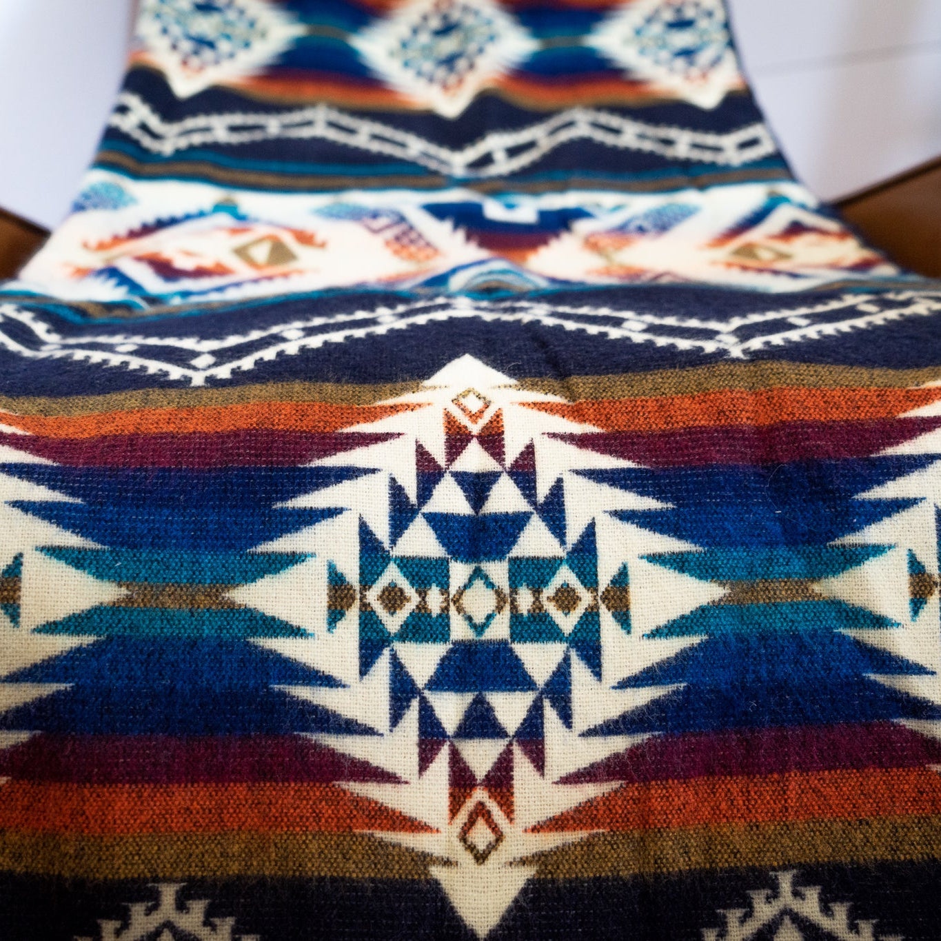 Navy, teal, rust and gold layered geometric alpaca blanket, view 10