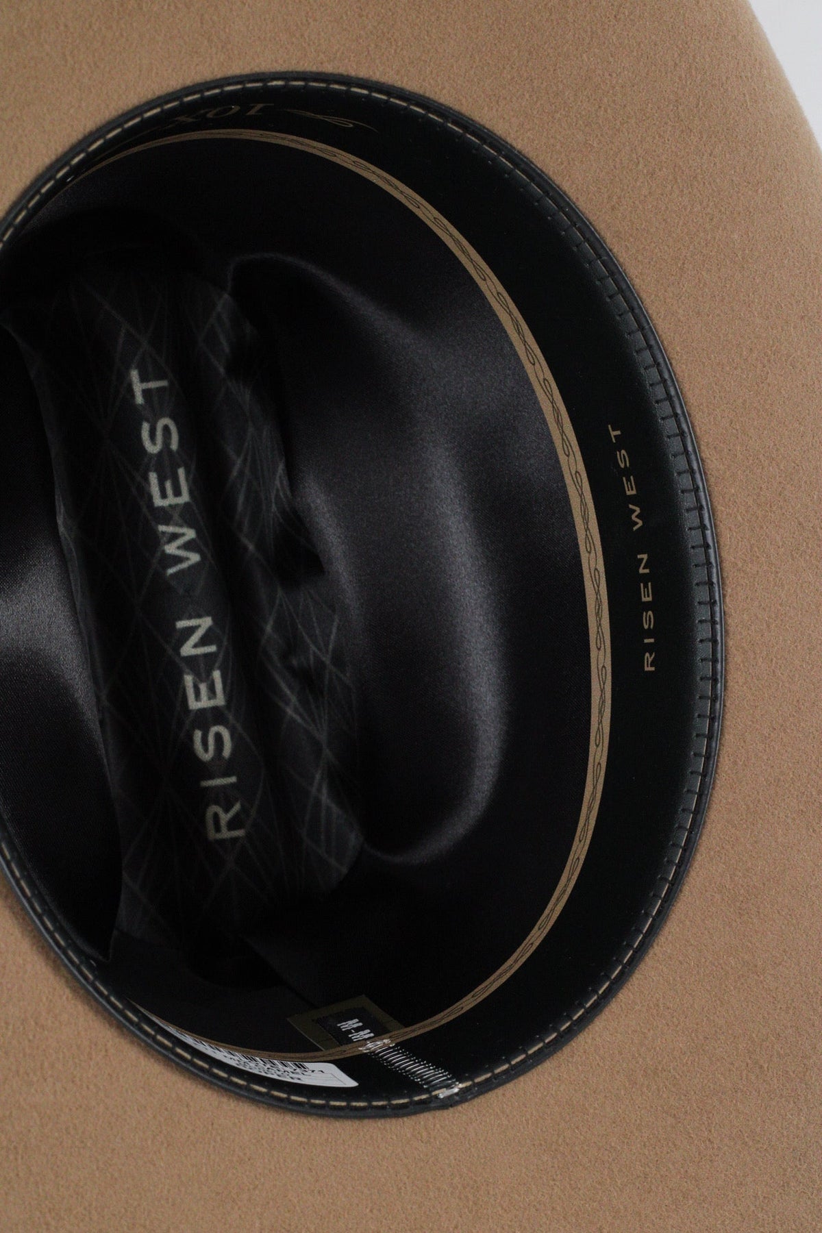 Close view inside the camel Wren cowboy hat showing the black satin lining and sweatband