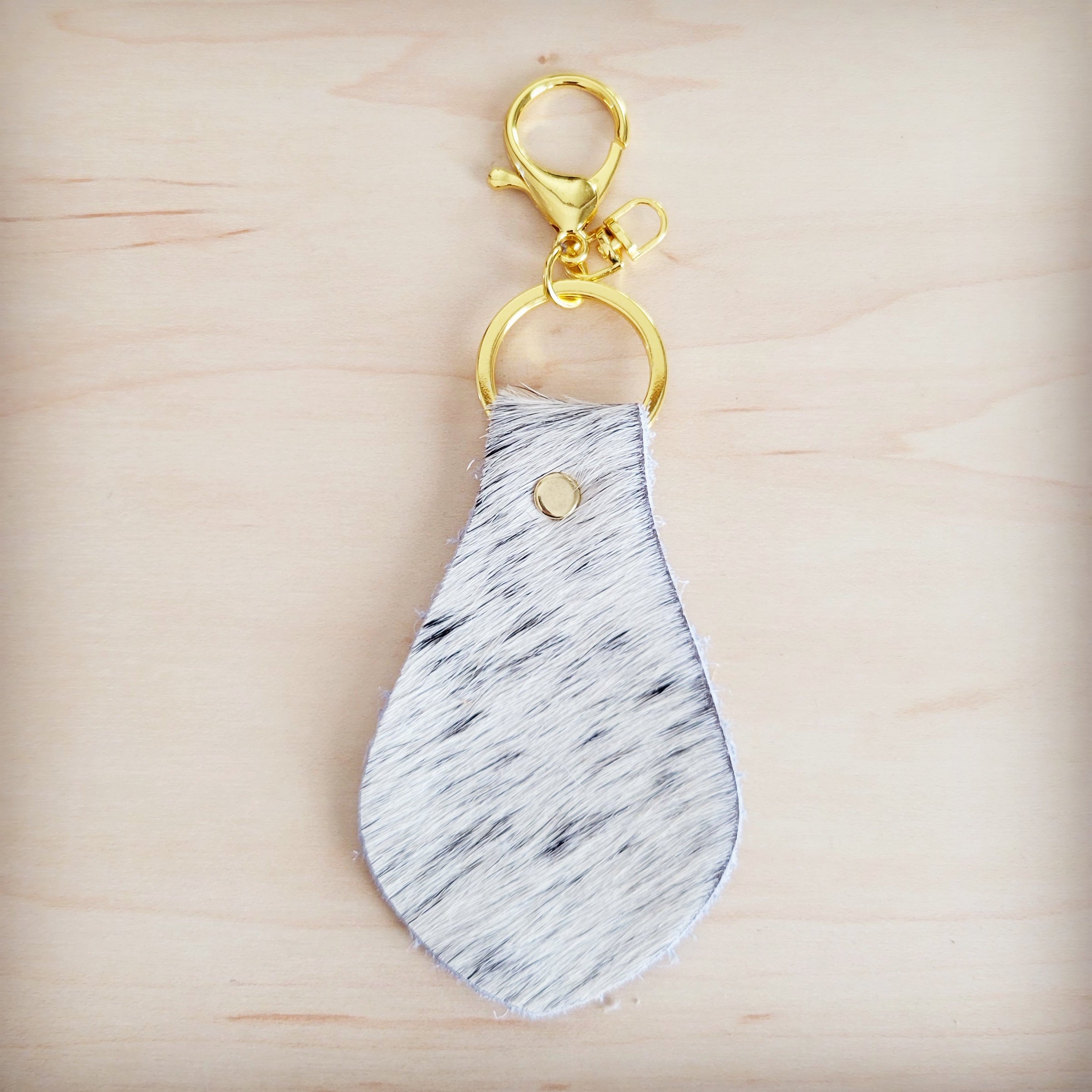 Brindle cowhide key chain shown beside other hair-on-hide key fobs