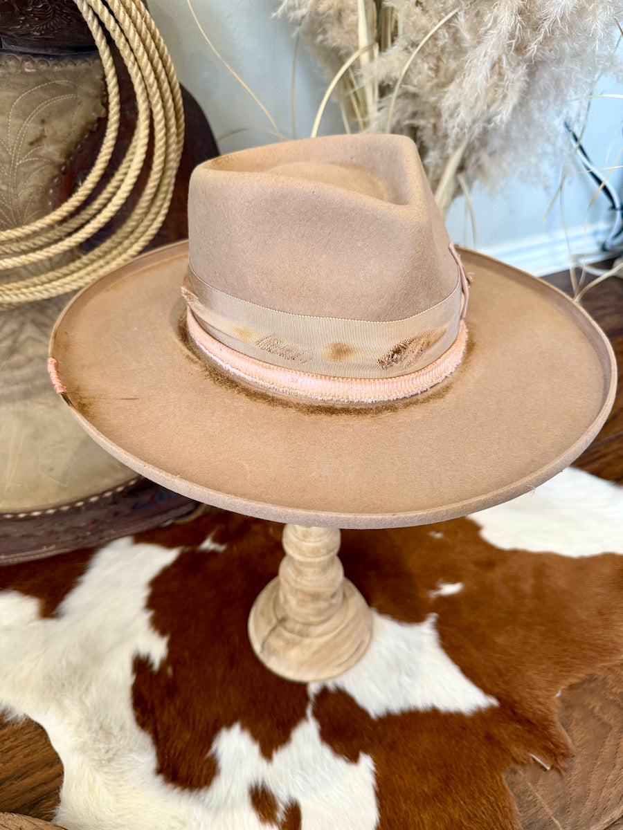Side profile of the camel felt rancher hat showing the wide flat bound brim and double ribbon band