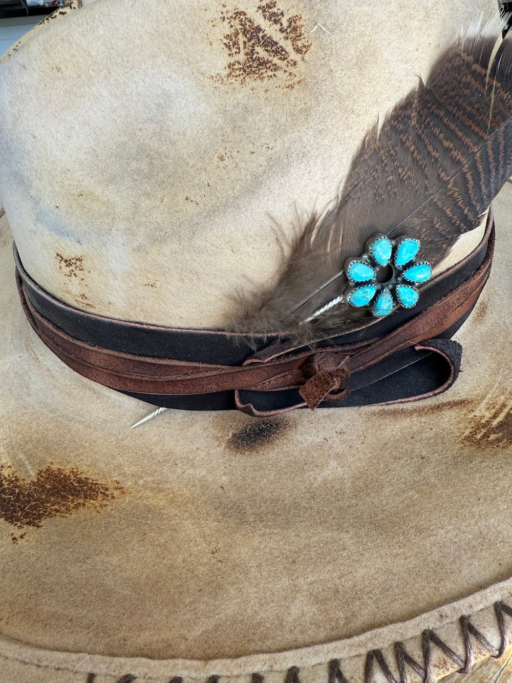 Kingman turquoise cluster hat pin in sterling silver pinned to a leather hat band