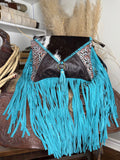 Western shoulder bag with a cowhide flap, turquoise tooled leather panels and long turquoise suede fringe