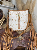 Western shoulder bag in white and cinnamon speckled hair-on cowhide with tan leather chevron lacing and long side fringe
