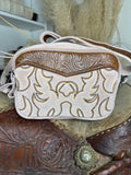 Cream suede western crossbody bag with gold corded boot stitch embroidery and a brown tooled leather yoke