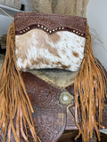Speckled cowhide western bag with a scalloped studded tooled leather yoke and long tan leather fringe