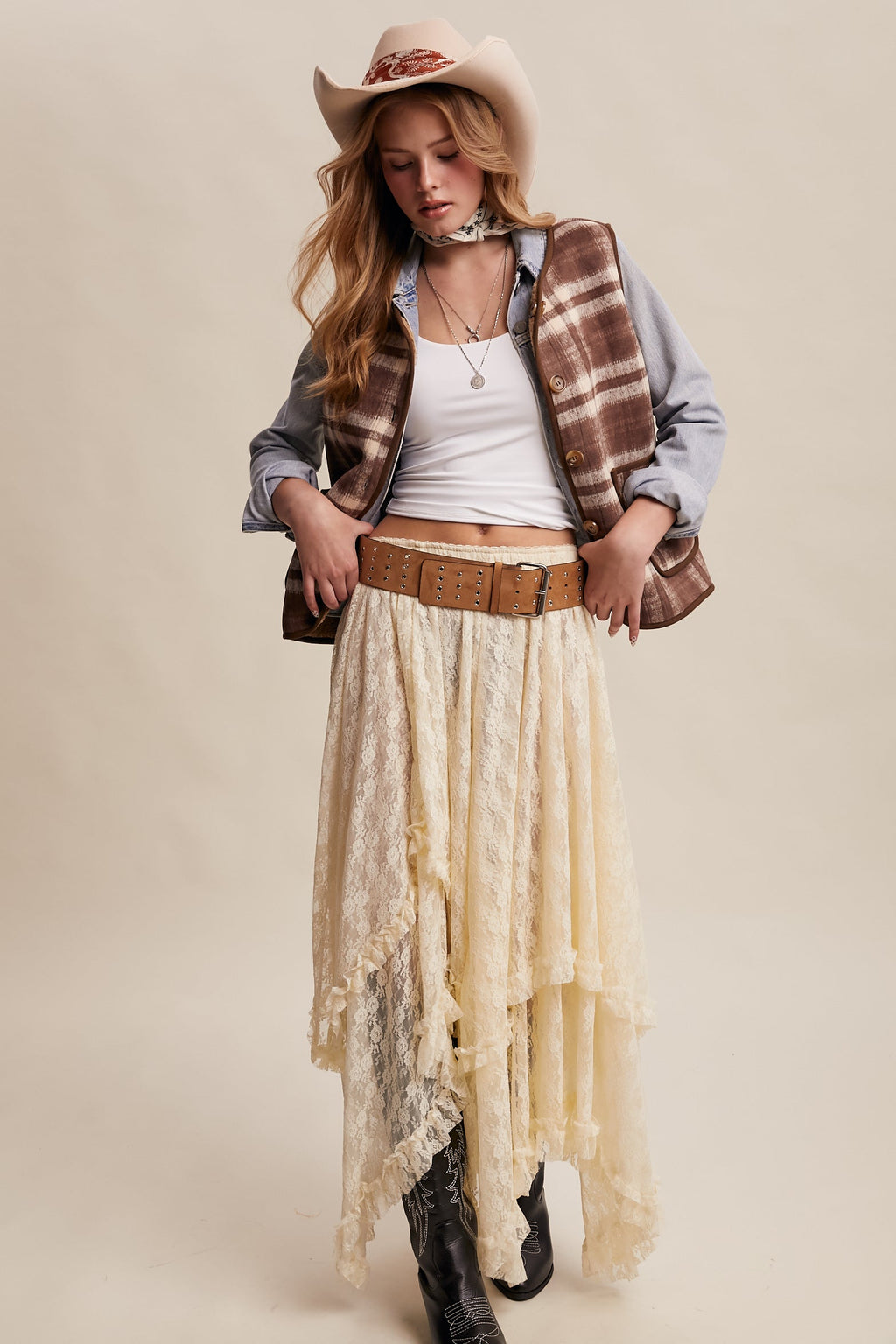 Brown plaid vest with sherpa lining, worn over a chambray shirt
