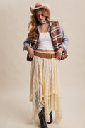 Brown plaid vest with sherpa lining, worn over a chambray shirt