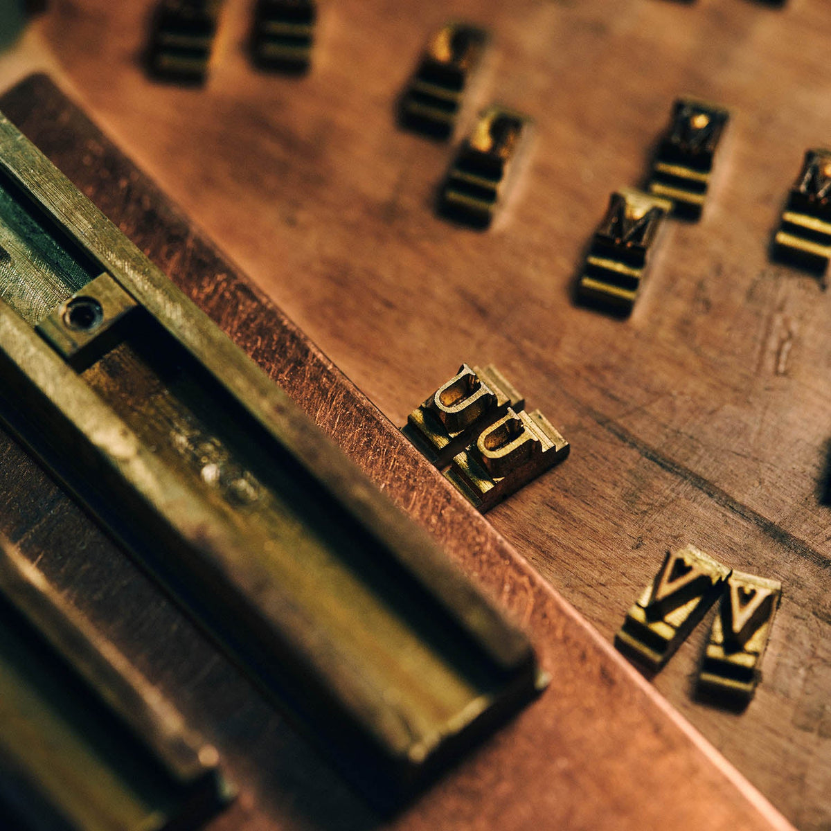 Monogram die being pressed into leather in the Rogue Industries workshop