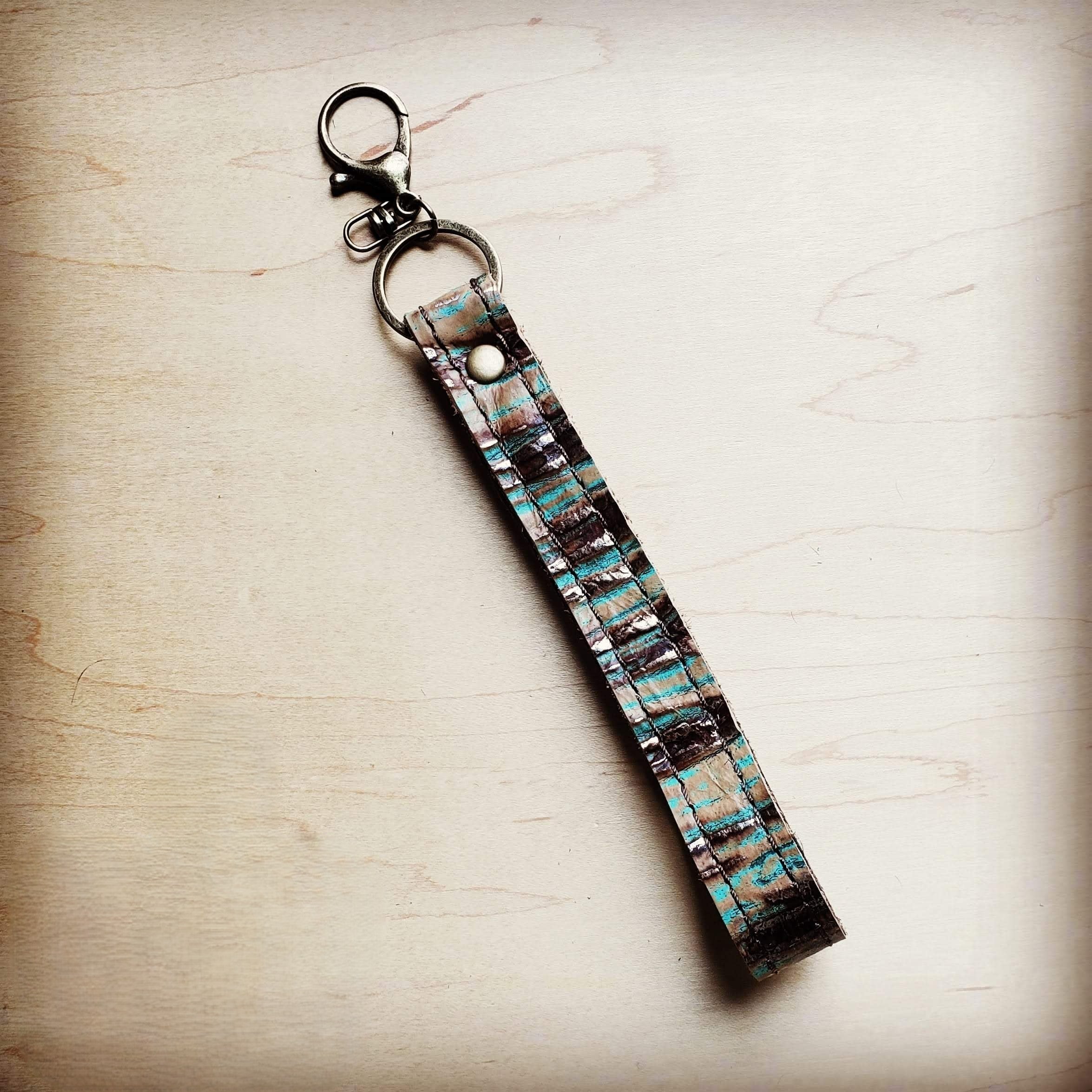 Turquoise and black embossed leather wristlet key chain with a swivel clip