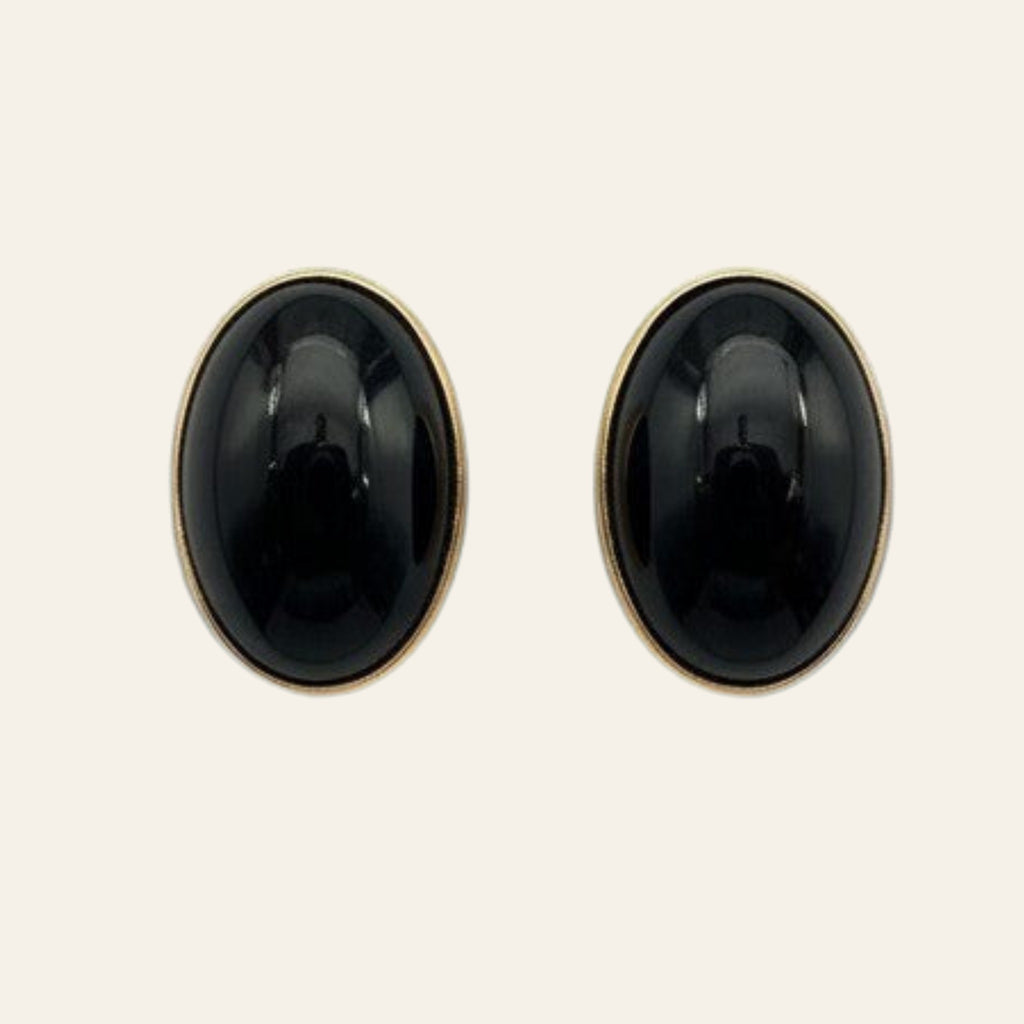Black Onyx Oval Stud Earrings in Solid 14K Gold, shown on a cream background