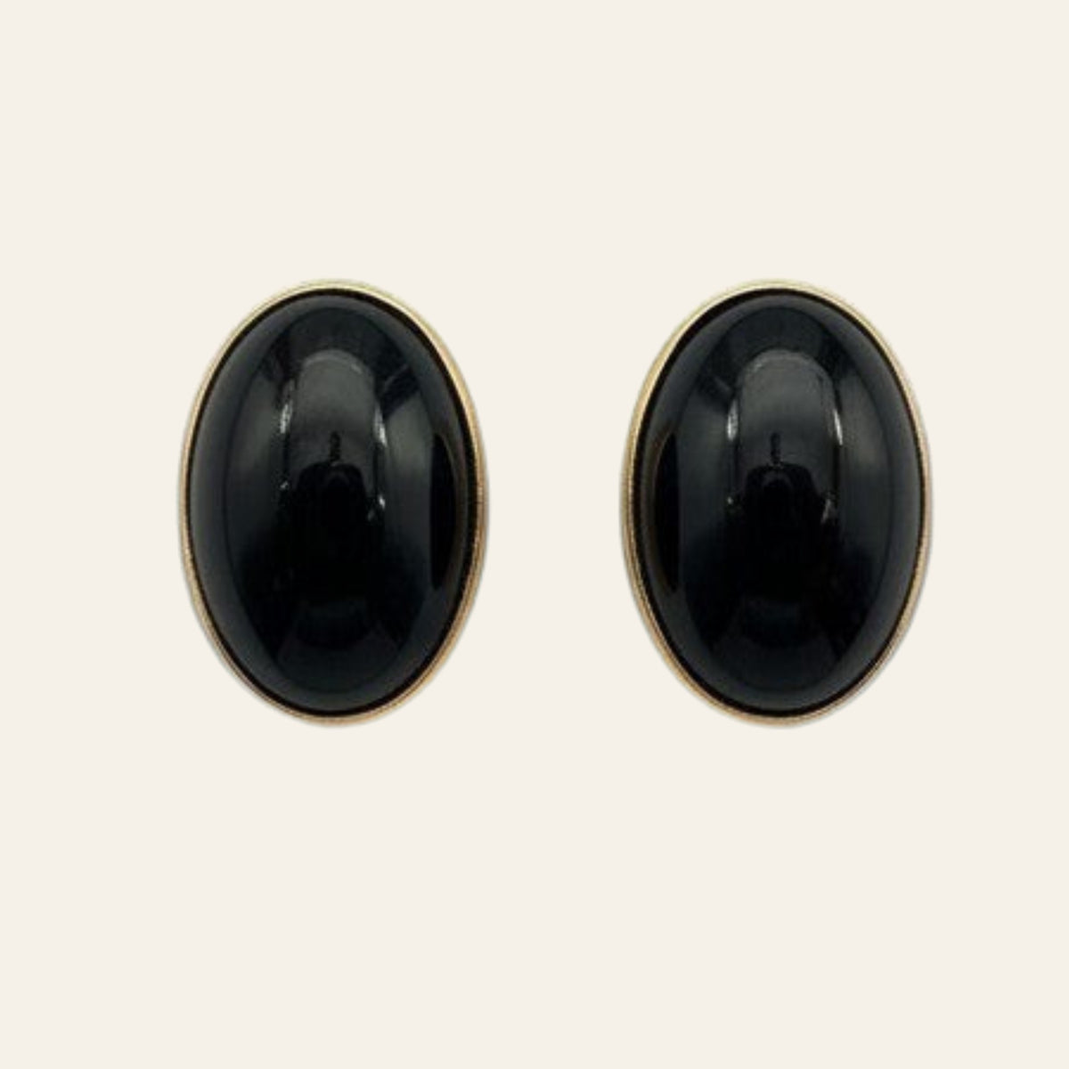 Black Onyx Oval Stud Earrings in Solid 14K Gold, shown on a cream background