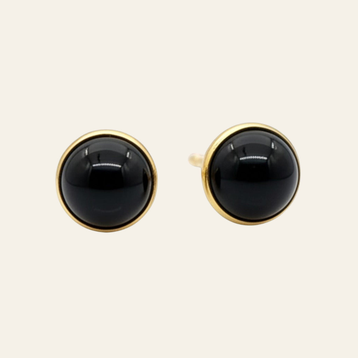 Black Onyx Round Mini Stud Earrings in Solid 14K Gold, shown on a cream background