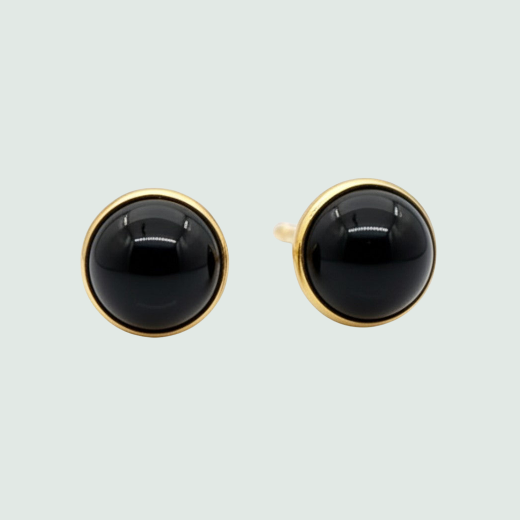 Black Onyx Round Mini Stud Earrings in Solid 14K Gold, shown on a sage mist background
